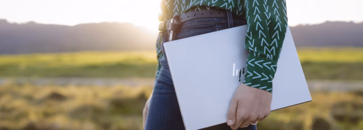 A person carrying a laptop underarm