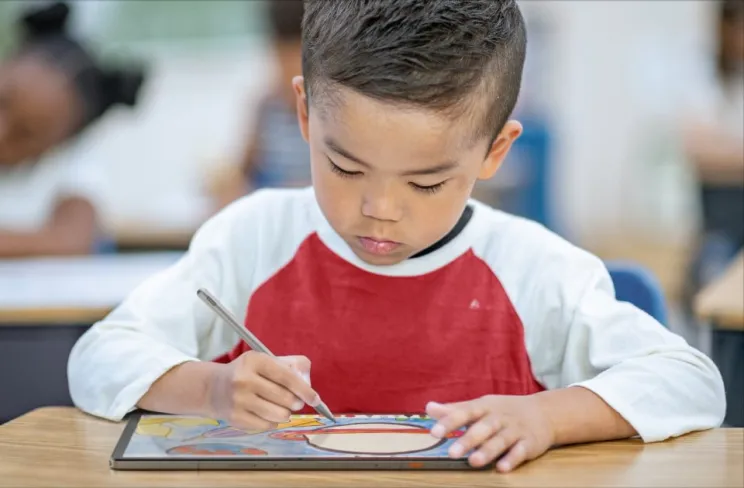 A child drawing on a tablet