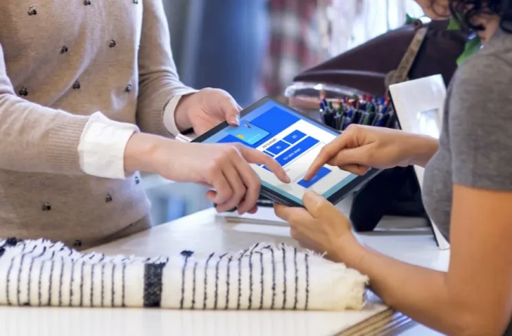 People pointing at a tablet