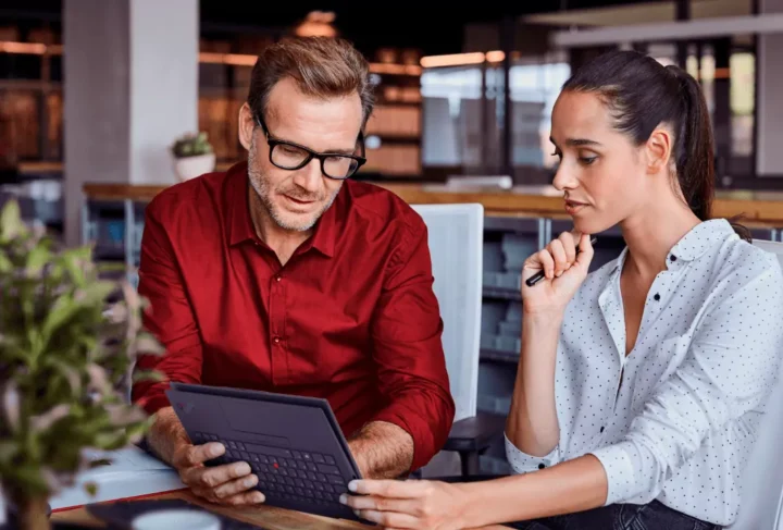 2 people looking at a tablet