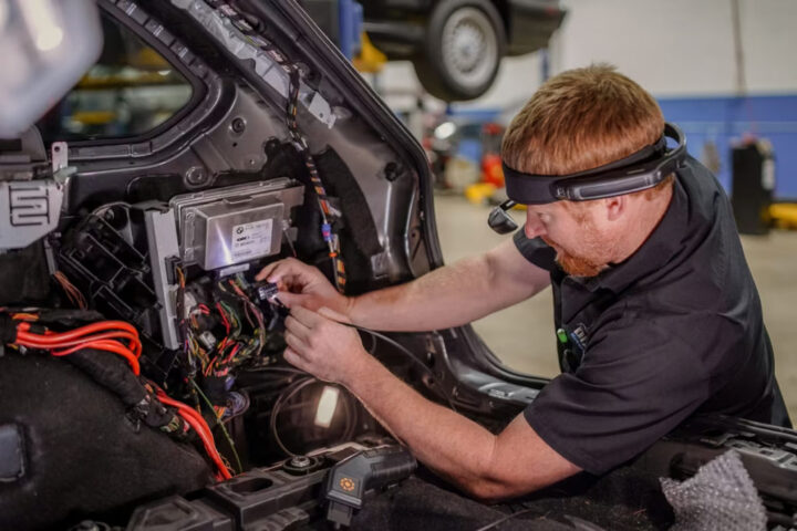 A person doing technical work with a RealWear headset on